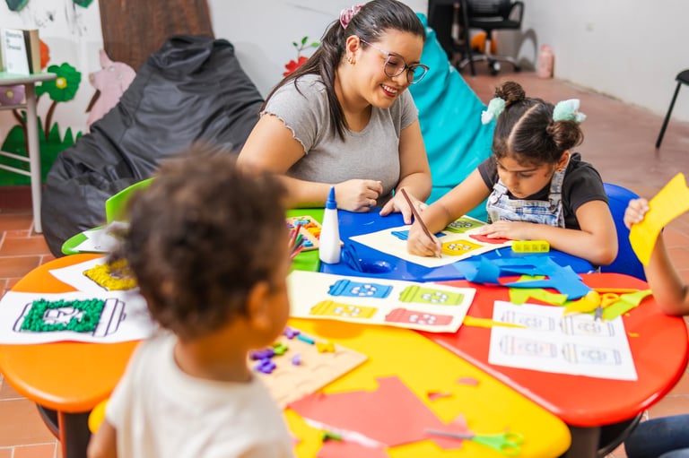 Teacher helping child with drawing