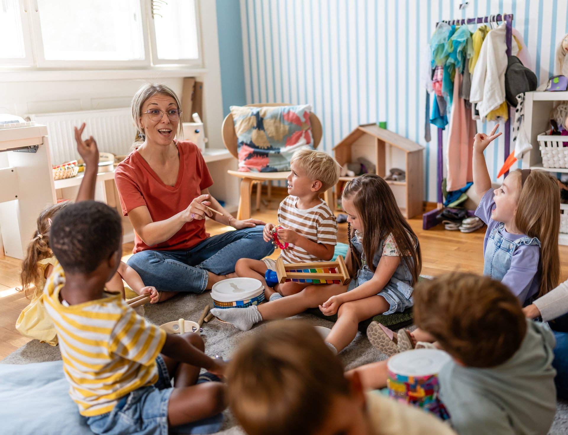 Teacher engaging children in a fun indoor activity